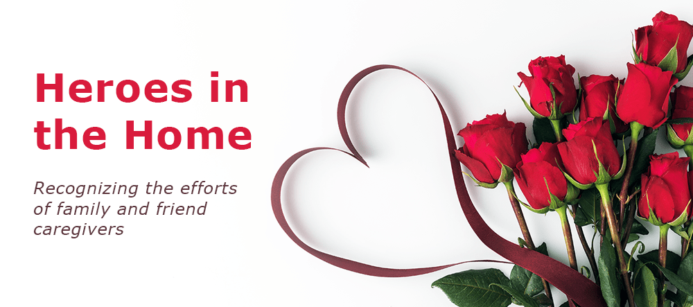 Top view of beautiful red roses with ribbon isolated on white with the words "Heroes in the Home".