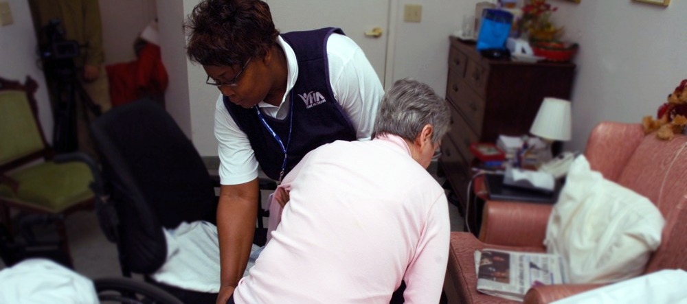 VHA PSW helps a client out of her bed