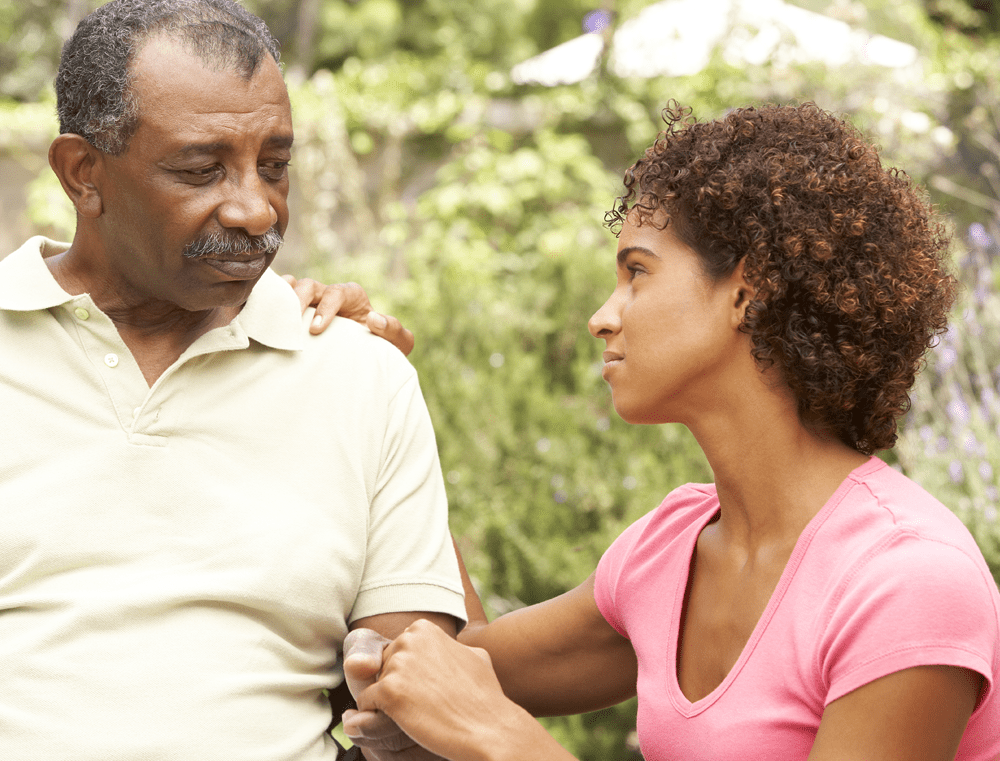 Senior Man Being Consoled By Adult Daughter