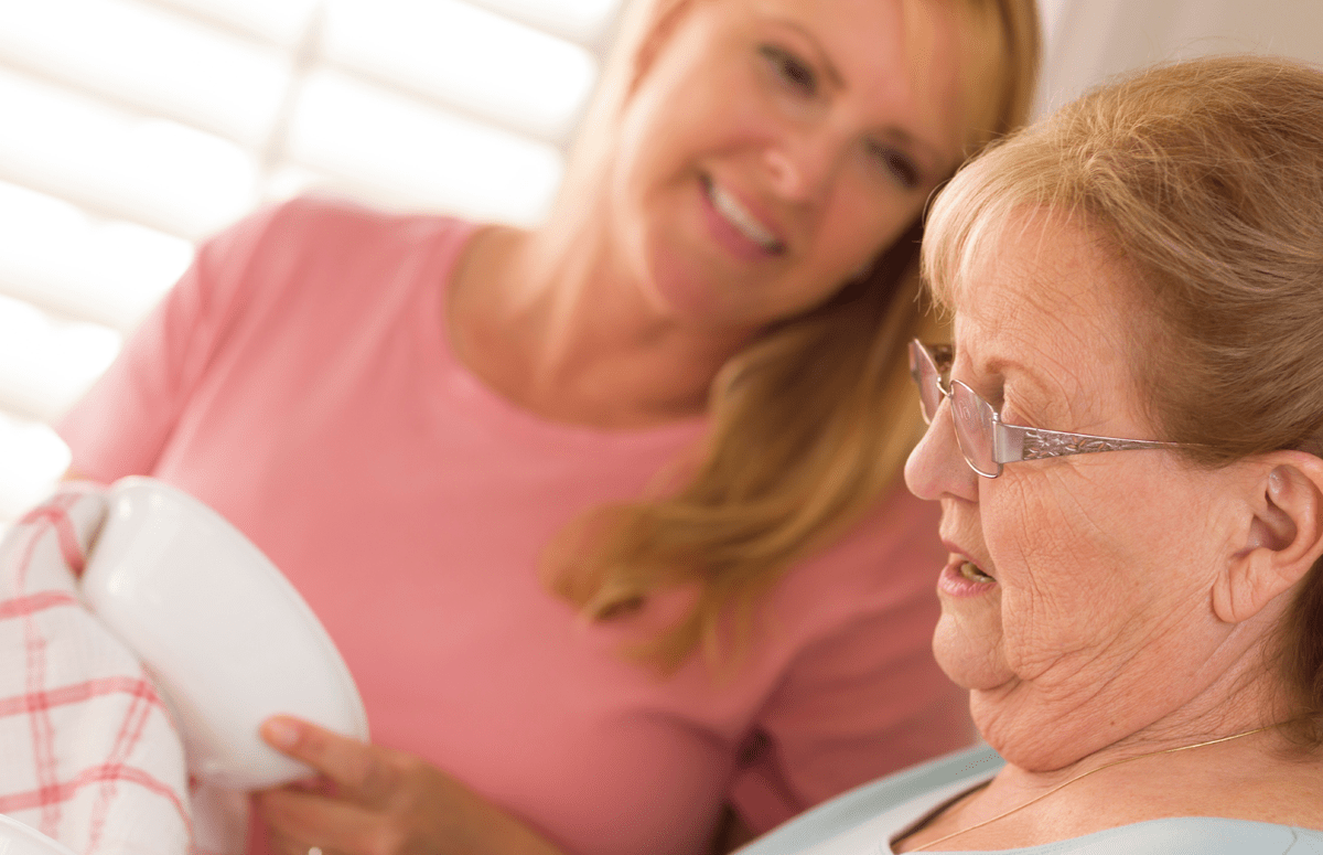 Young adult women speaks with elderly mom