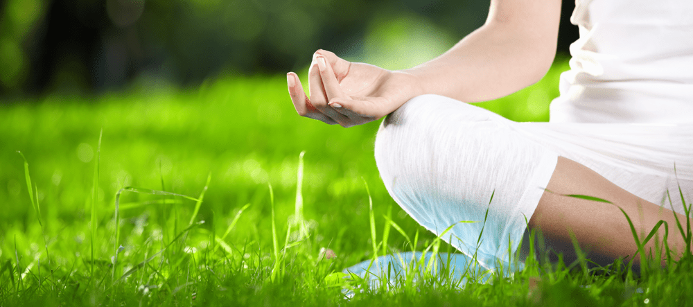 Person meditating outside