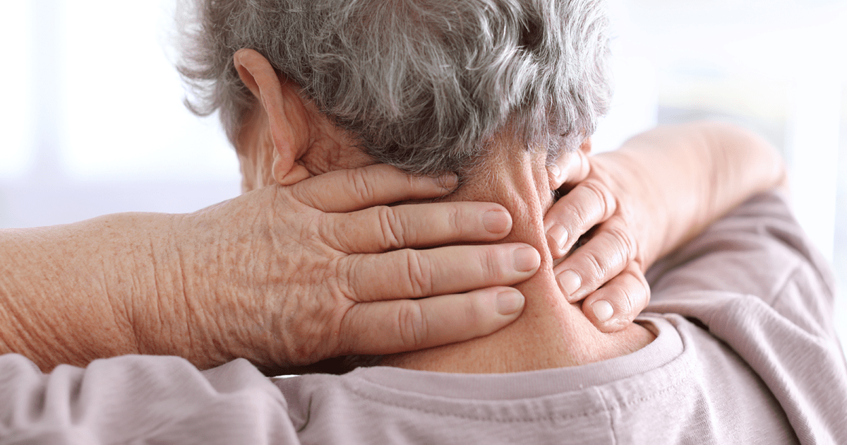 Elderly woman suffering from neck pain, closeup