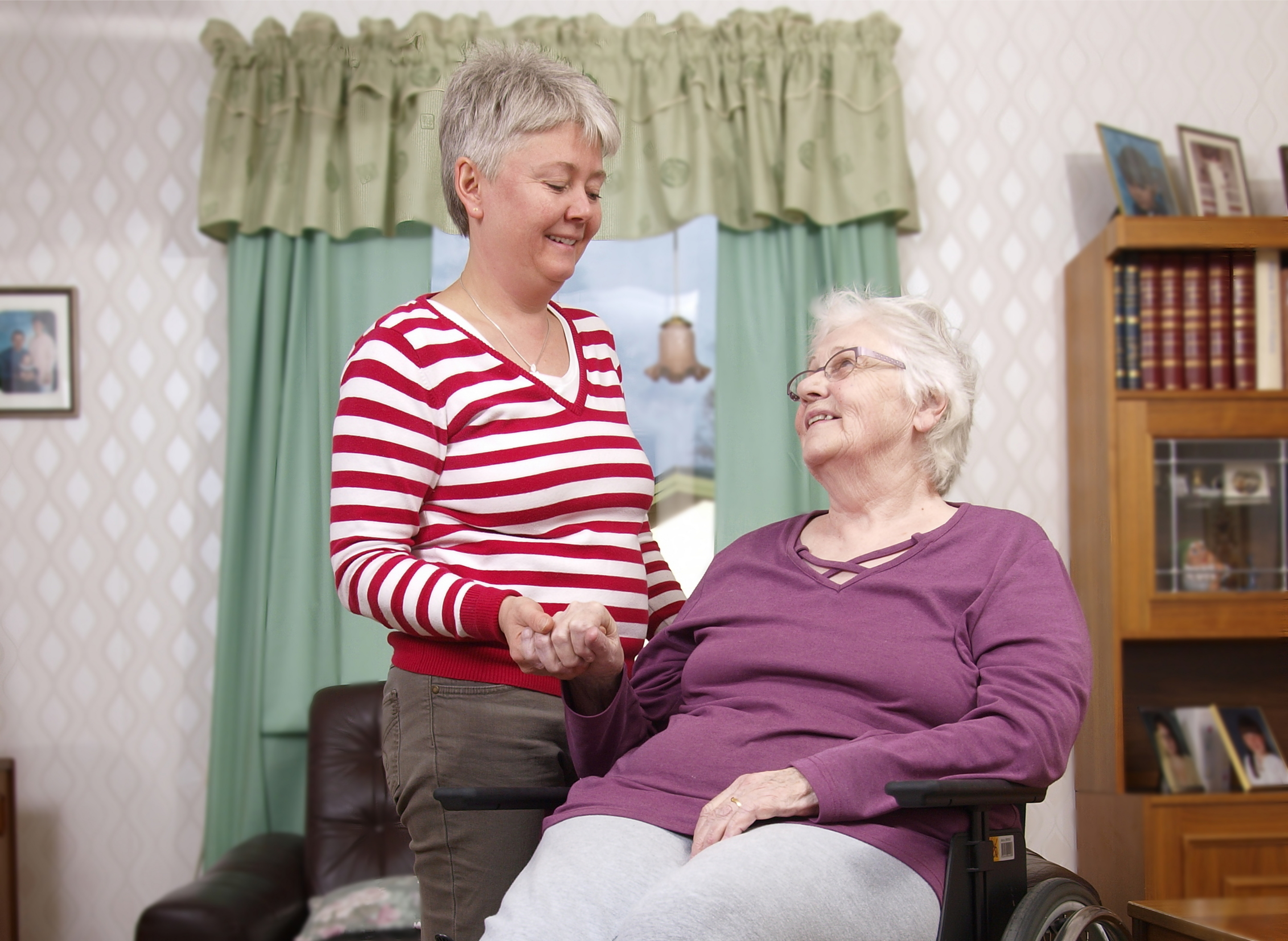 Two women holding hands