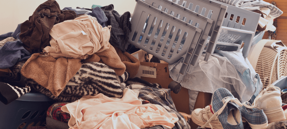 Pile of clothing and items in a home