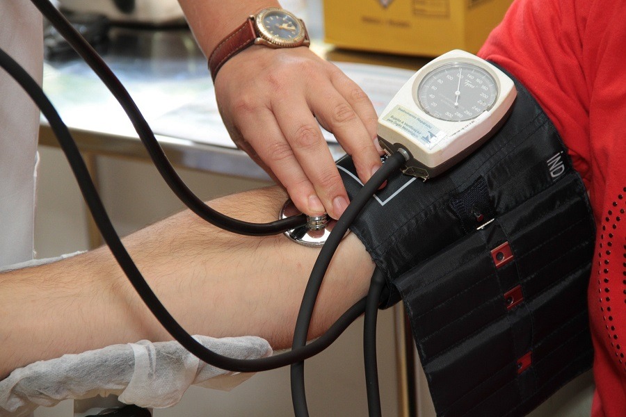 Doctor checking a person's blood pressure