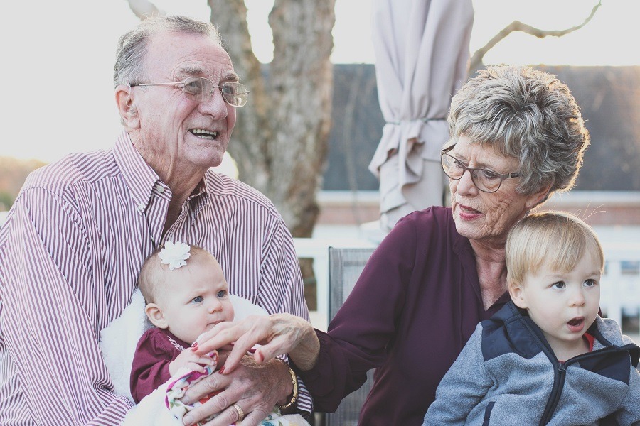 Elderly couple with their grandchildren