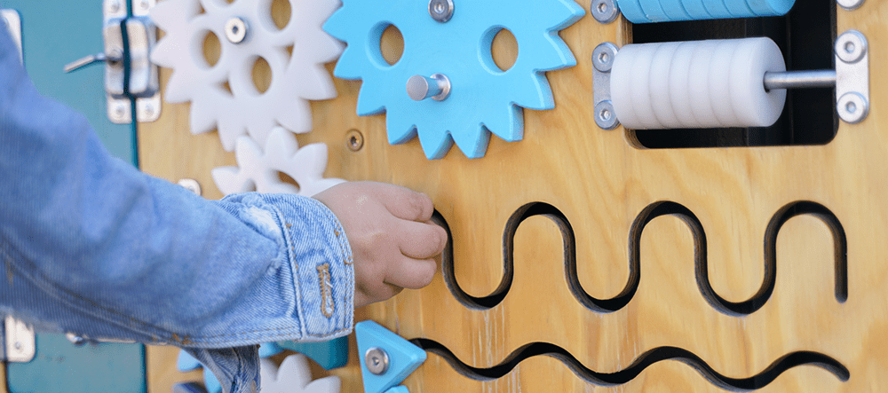 Child playing with a busy sensor board