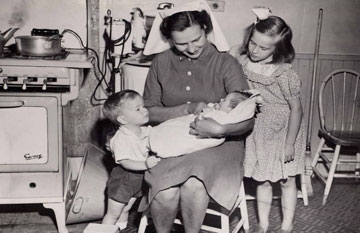 Black and white photo of VHA employee with three children