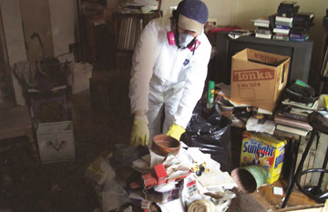Hoarding support employee doing cleanup