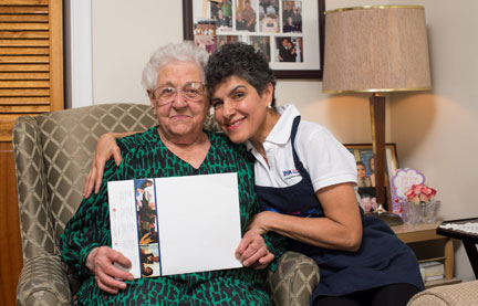 PSW and her client holding up a book