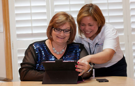 PSW and her client smiling at an iPad