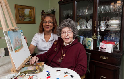 PSW and her smiling client in front of a painting easel