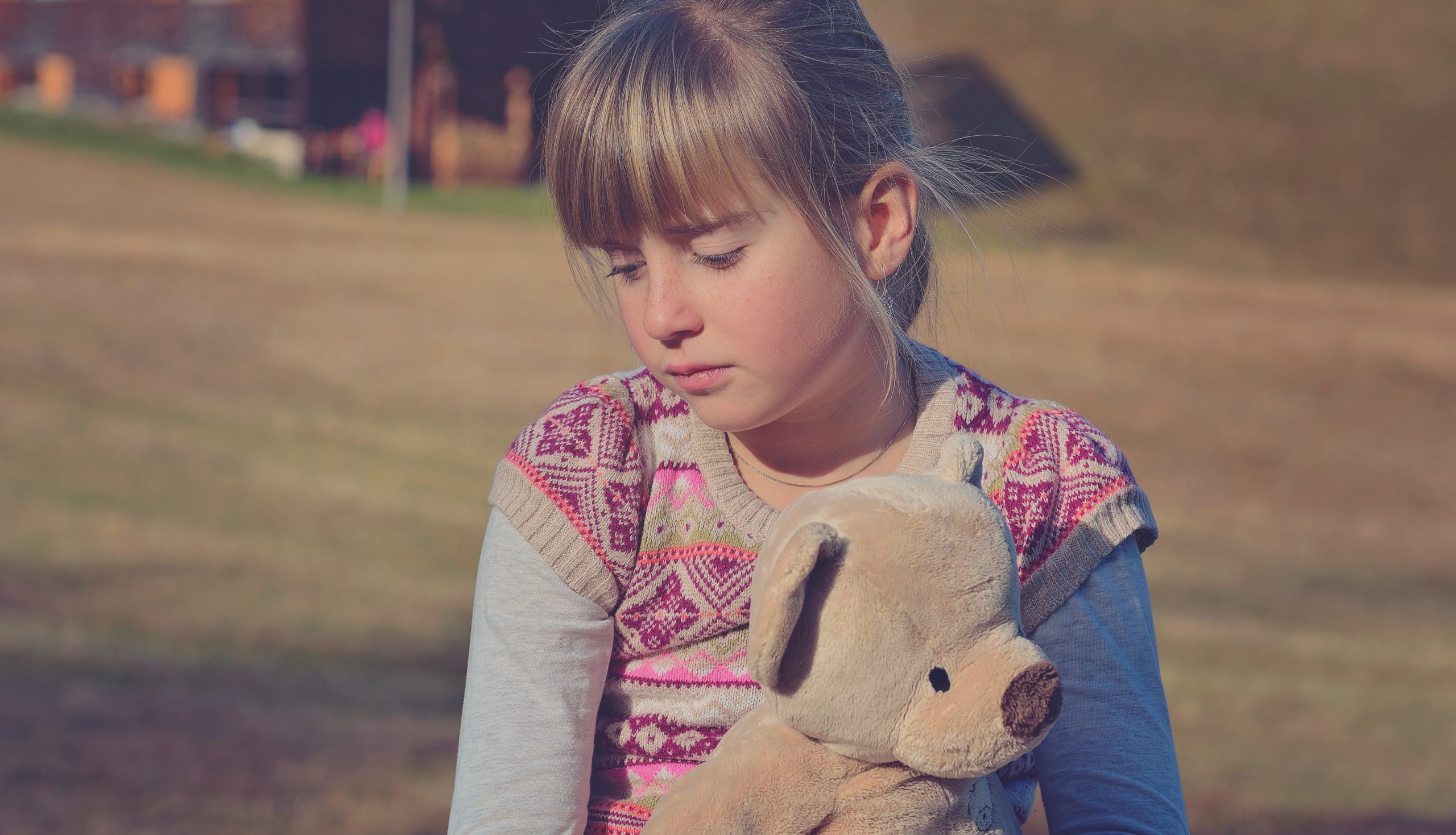 Sad little girl with teddy bear