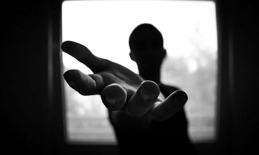 Silhouette of a man, reaching out to the camera