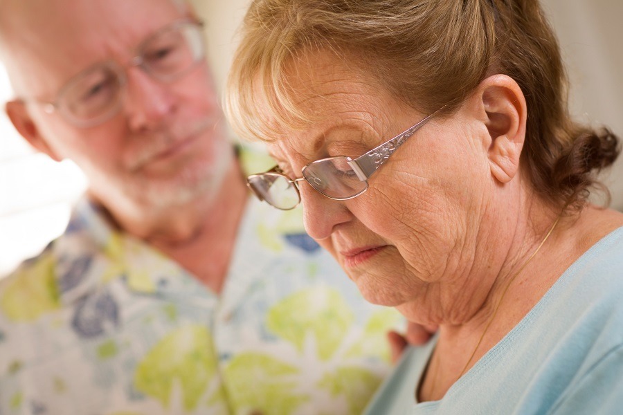 Elderly women with man in background