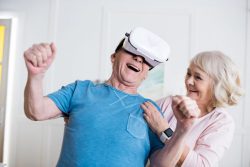 Senior couple, husband is wearing a virtual reality headset