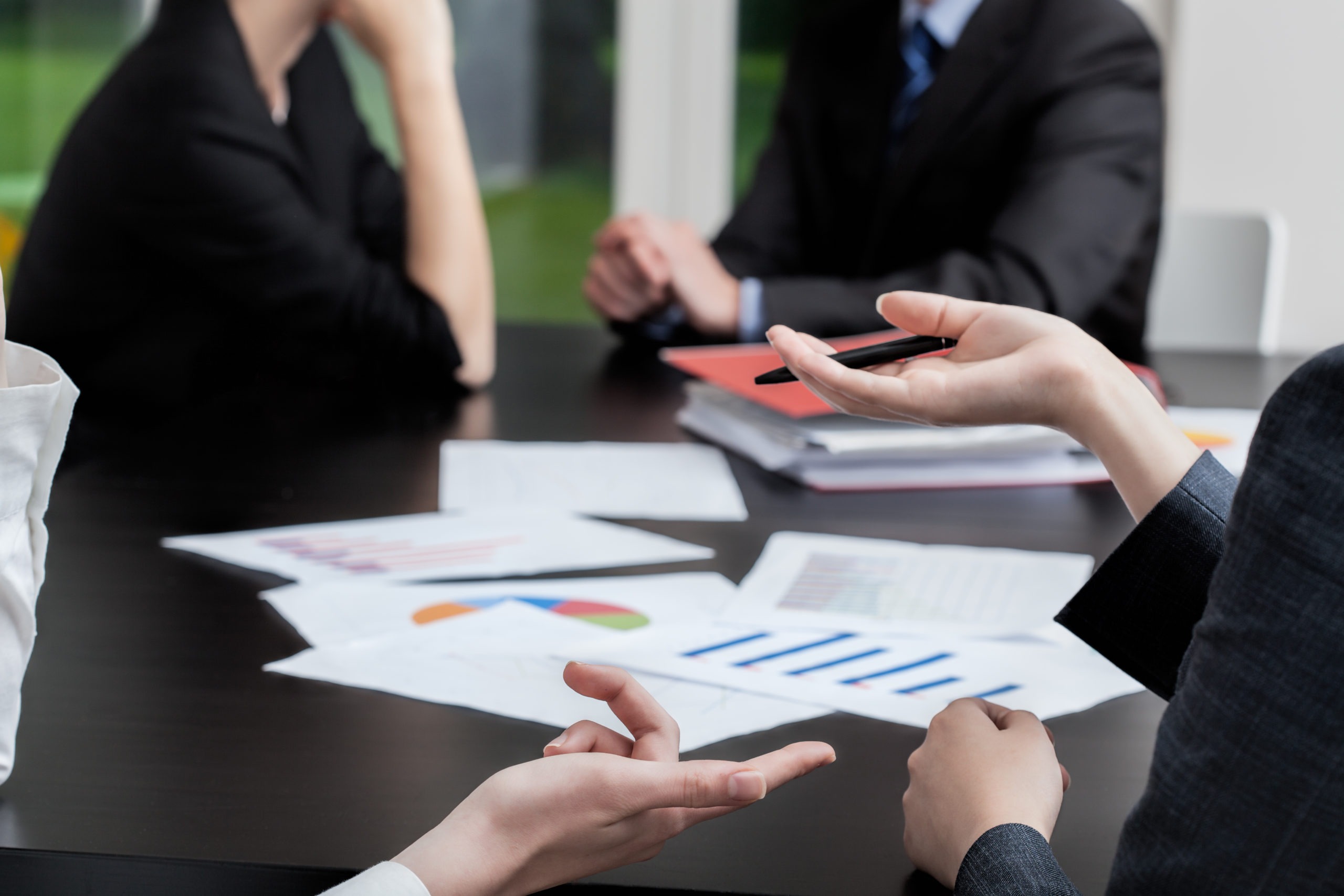 People working around a table covered in papers