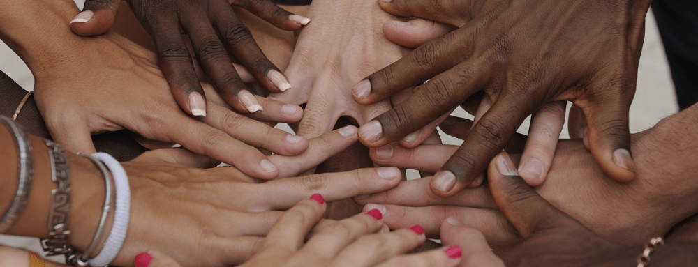 Many hands together: group of joining hands