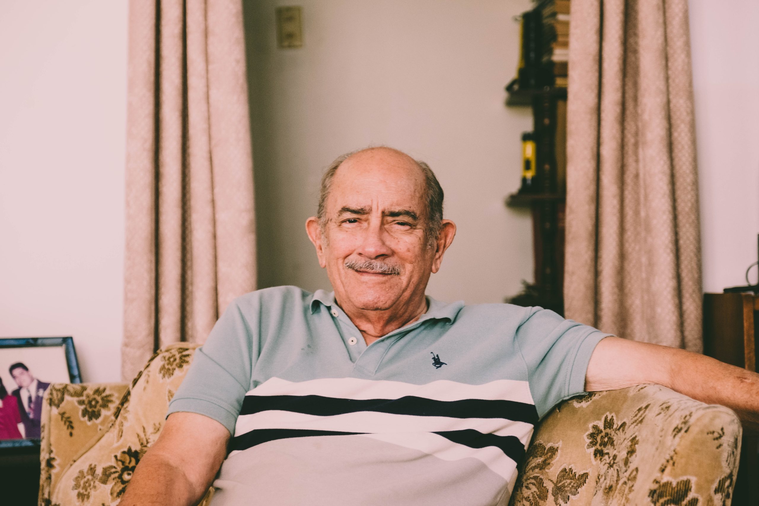 Senior sitting on a couch in his home