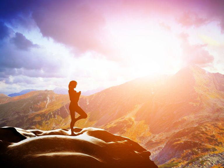 Person Standing on a Mountain