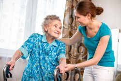 Health care worker helping senior in home