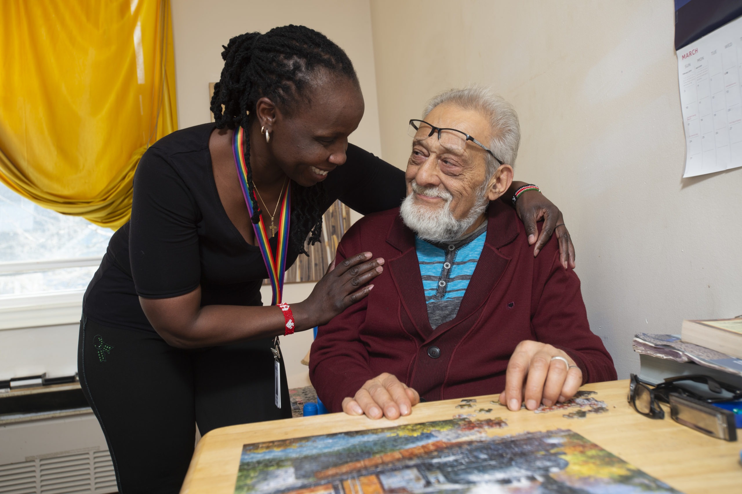 PSW stands by client as he completes a puzzle