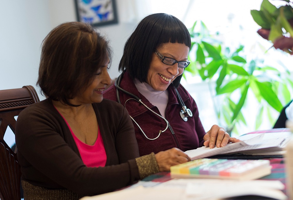 VHA nurse and client looking at a papers together