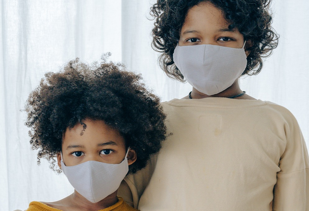 Children wearing face masks in home