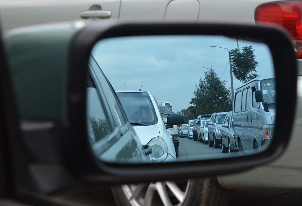 A driver's side mirror showing traffic