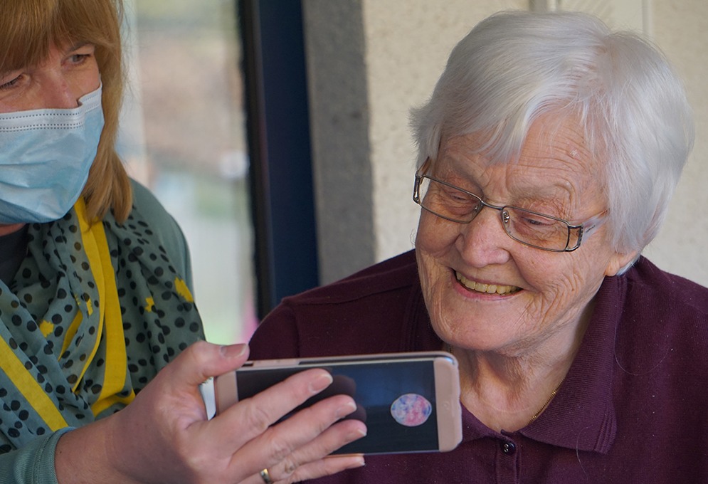 Senior looking at a cellphone video