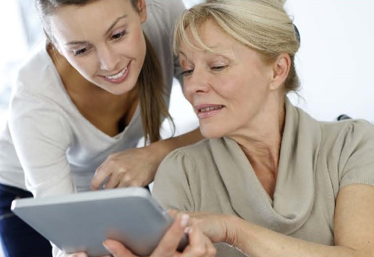Two women looking at a tablet screen