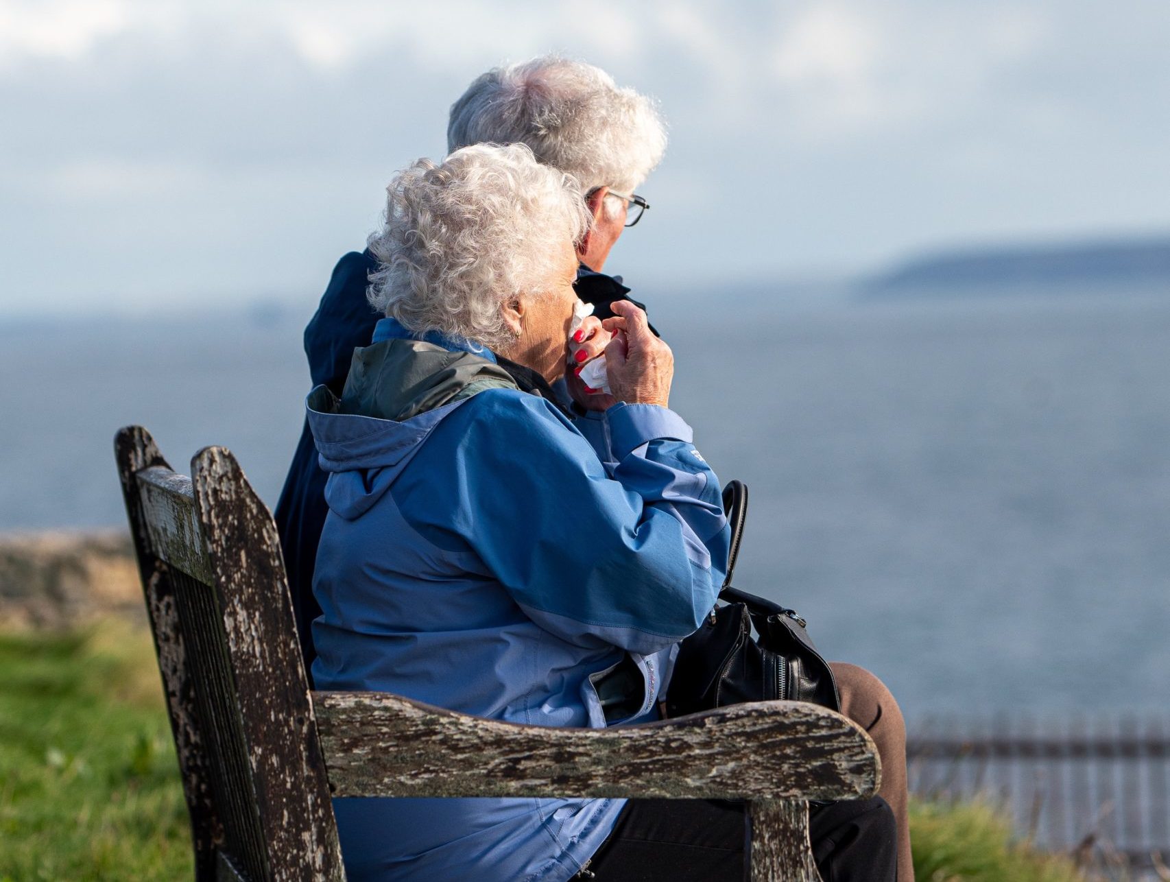 Two seniors sitting on a bench