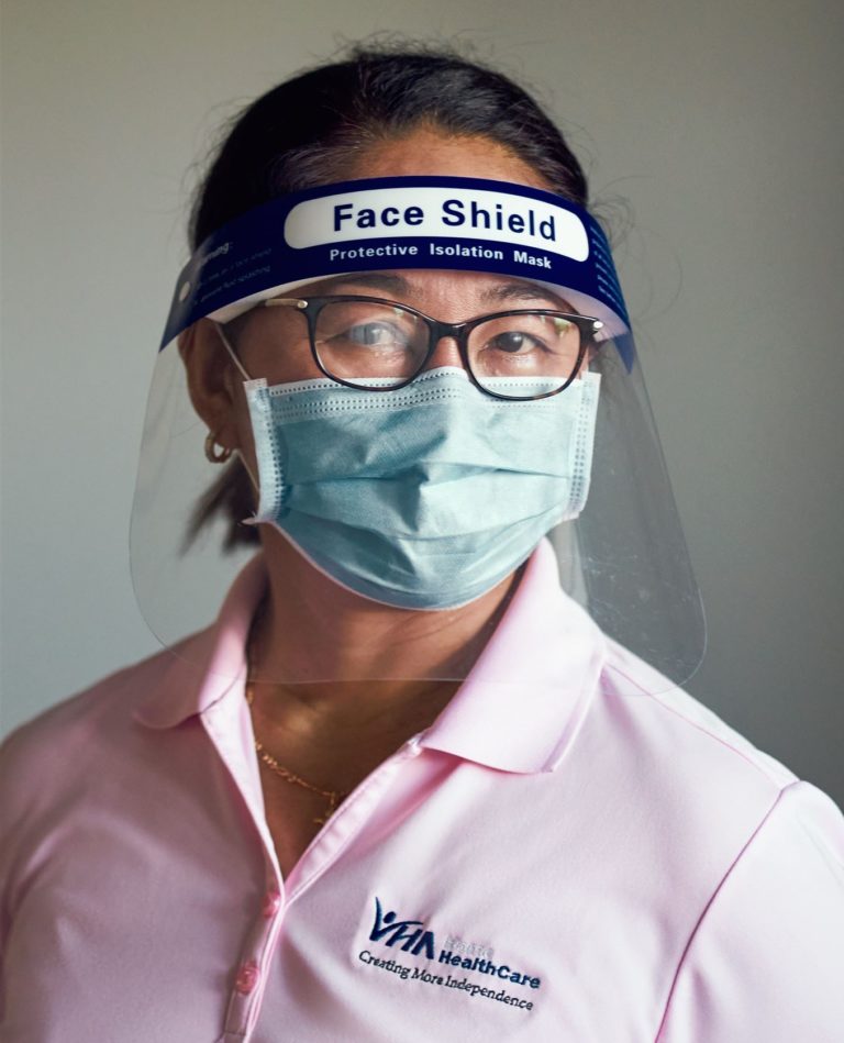 Personal support worker wearing a mask and face shield