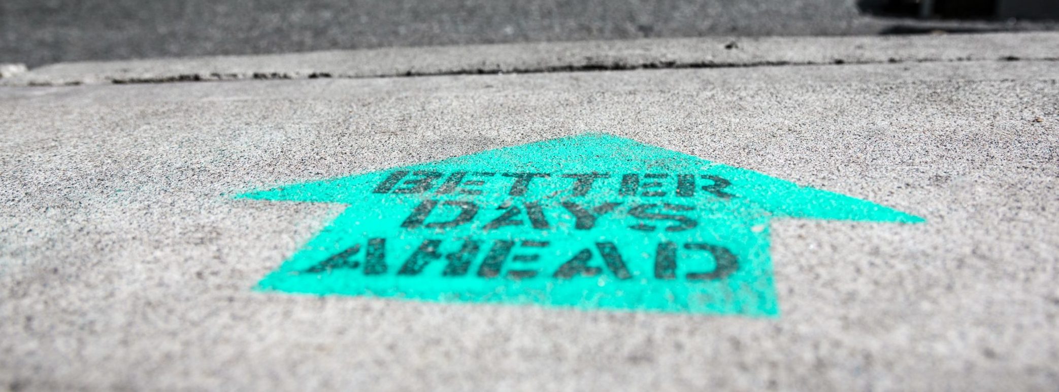 Painted arrow on ground saying "Better Days Ahead"