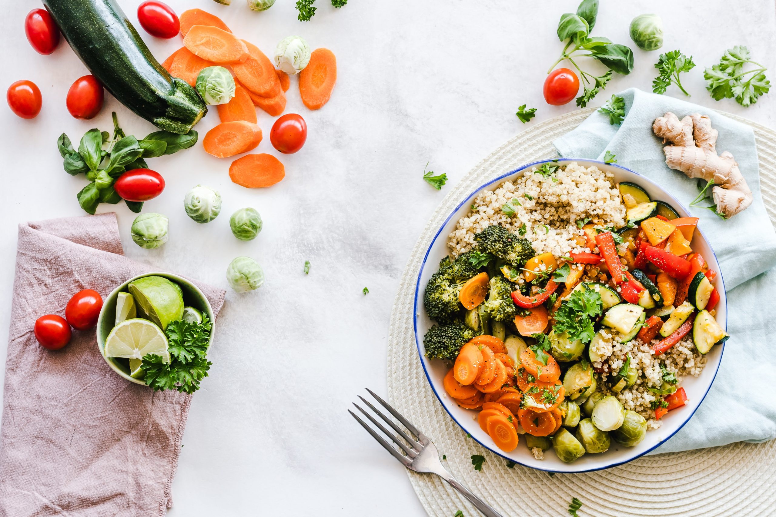 Picture of a salad bowl with healthy foods scattered around it artistically