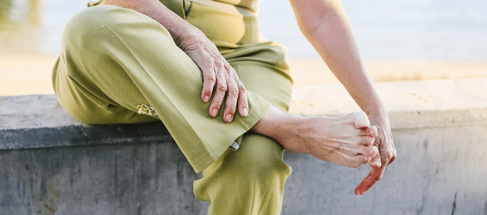 Close up of women dusting off feet on beach