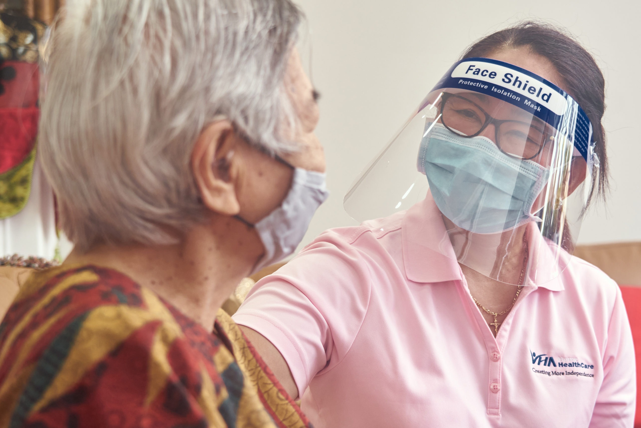 PSW wearing mask and face shield with a client