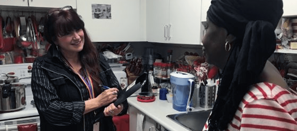 VHA's Trudy Huet speaks with hoarding client in kitchen