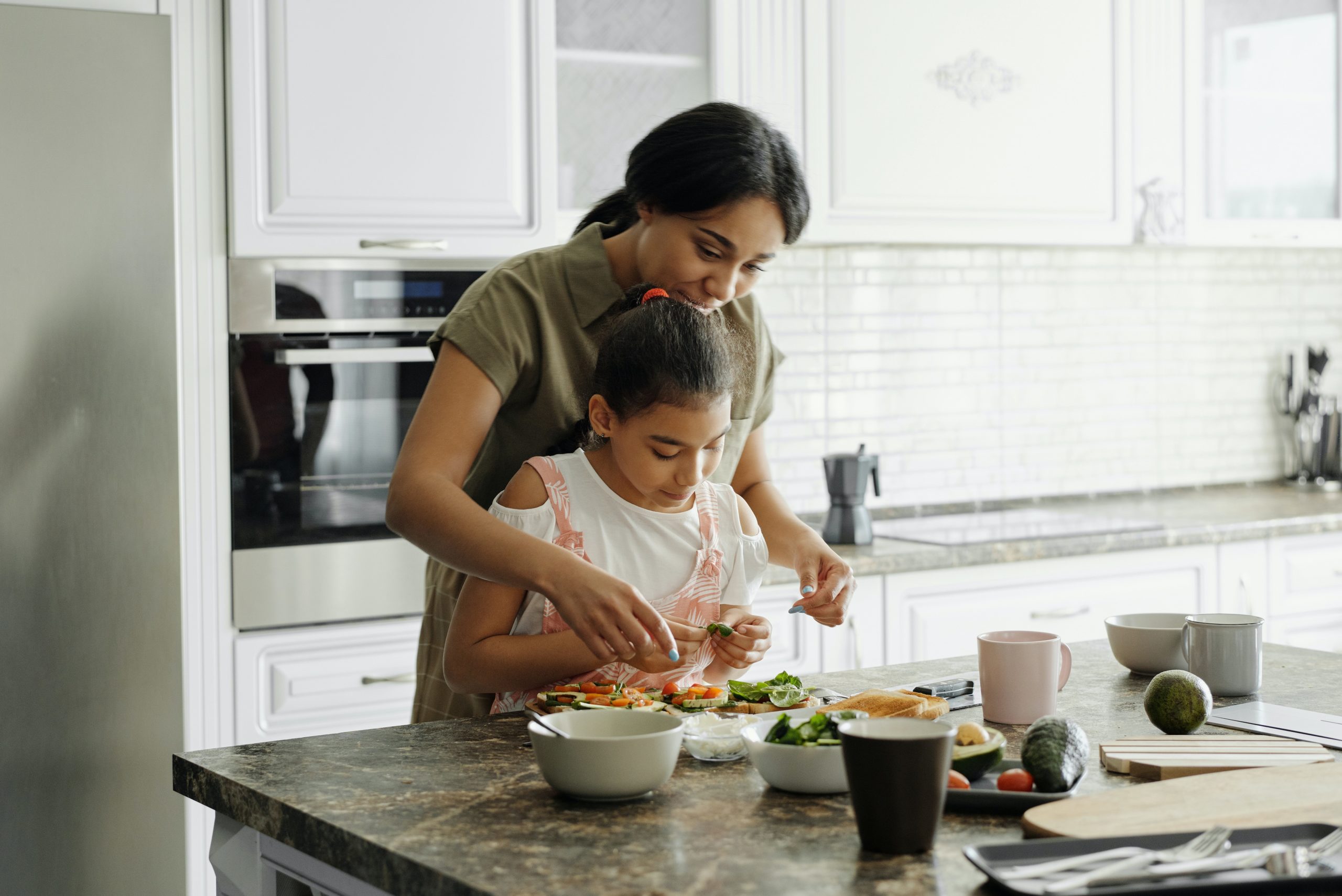 Woman and her daughter in the kitchen
