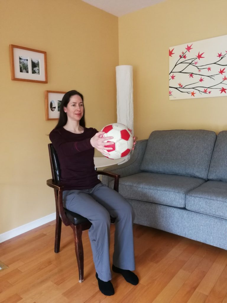 Woman holding a ball in front of her