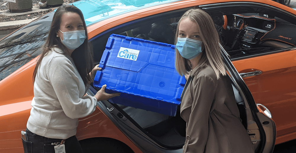 Krista Keilty poses with a Connected Care on the Go Box