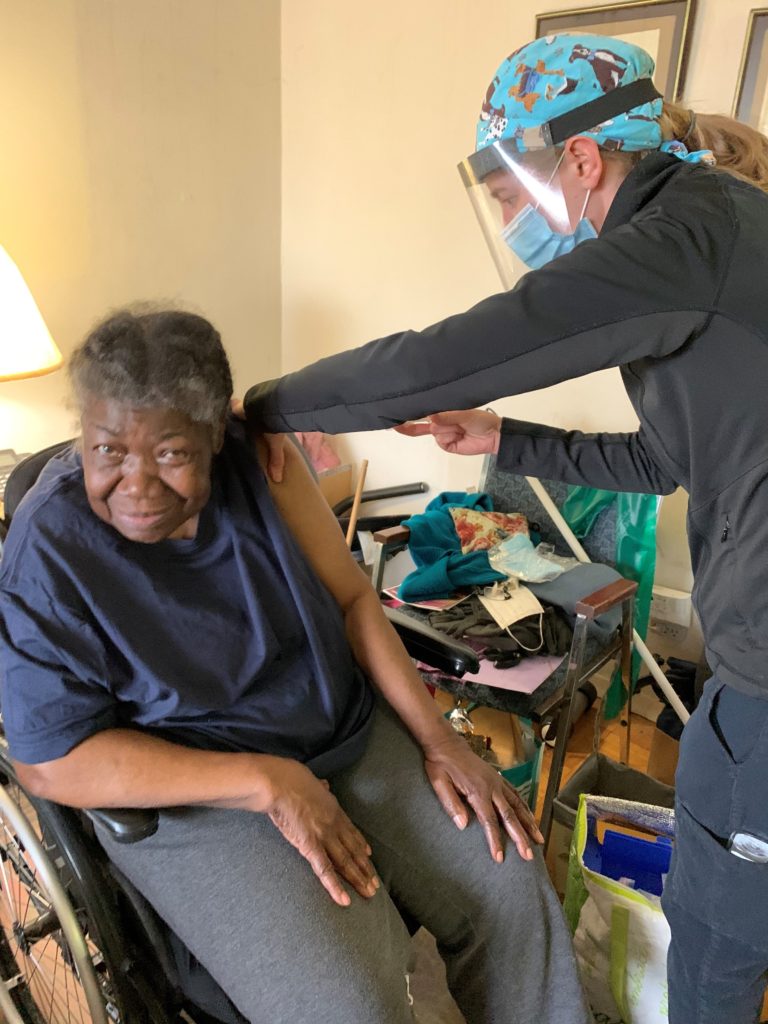 Client receiving vaccine at home