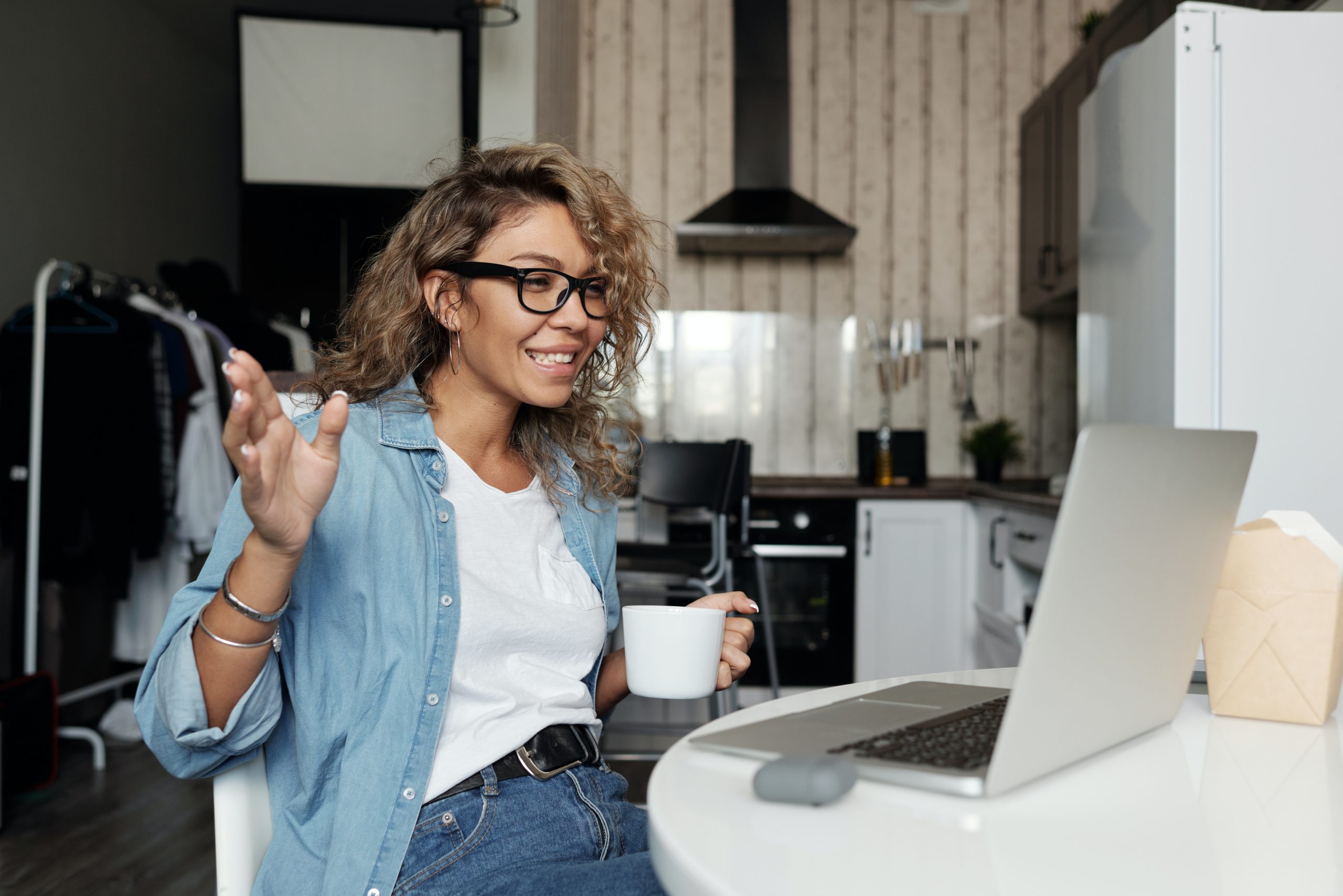 Woman smiling at a laptop computer