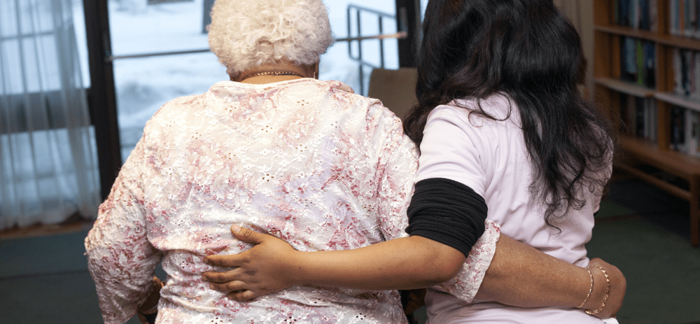 A VHA Personal Support Worker walks with a client