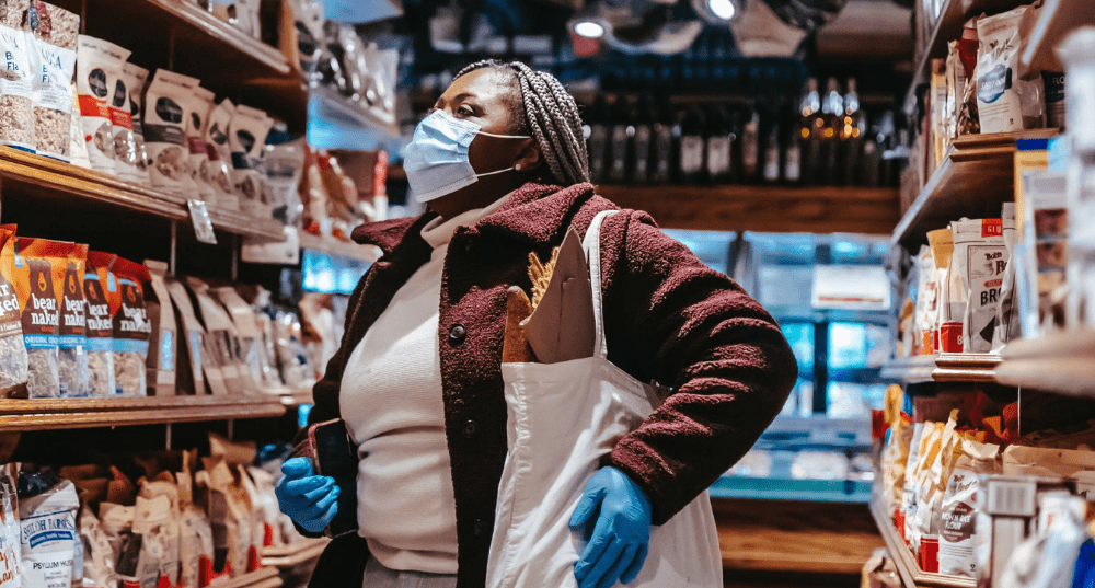 A woman in a grocery store aisle