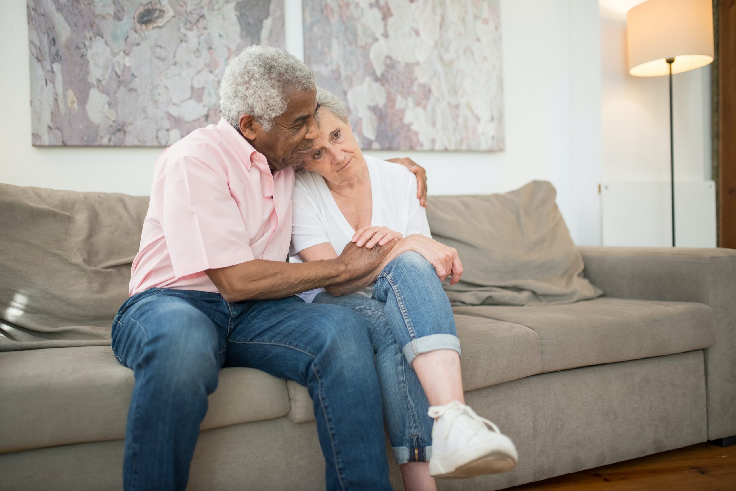 Woman and man sitting on couch