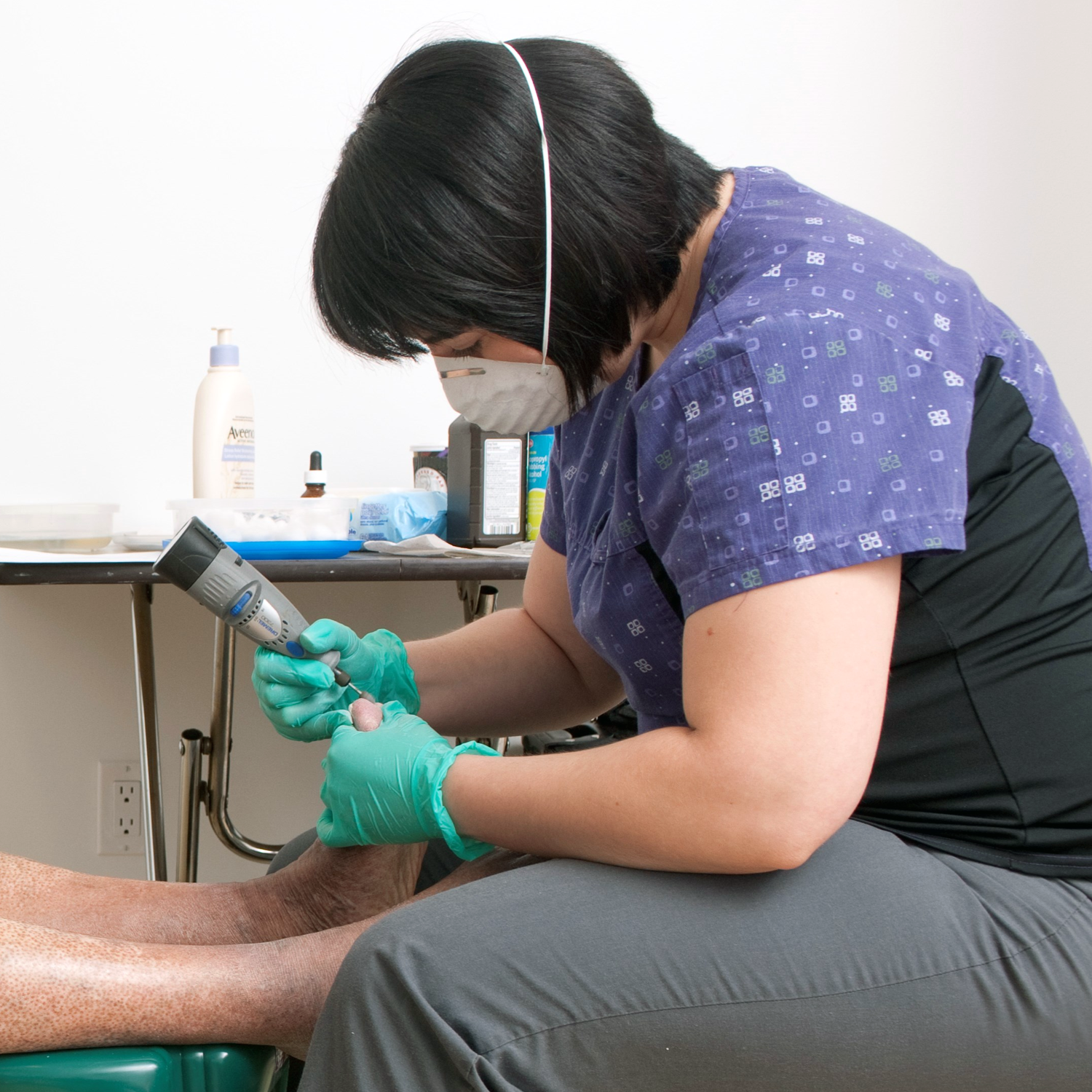 Nurse provides foot care to client