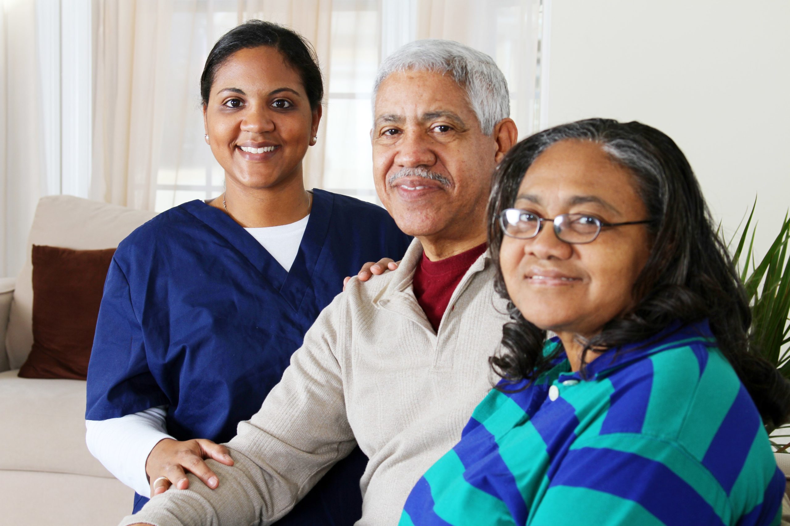 Elderly man pictured with wife and paid caregiver