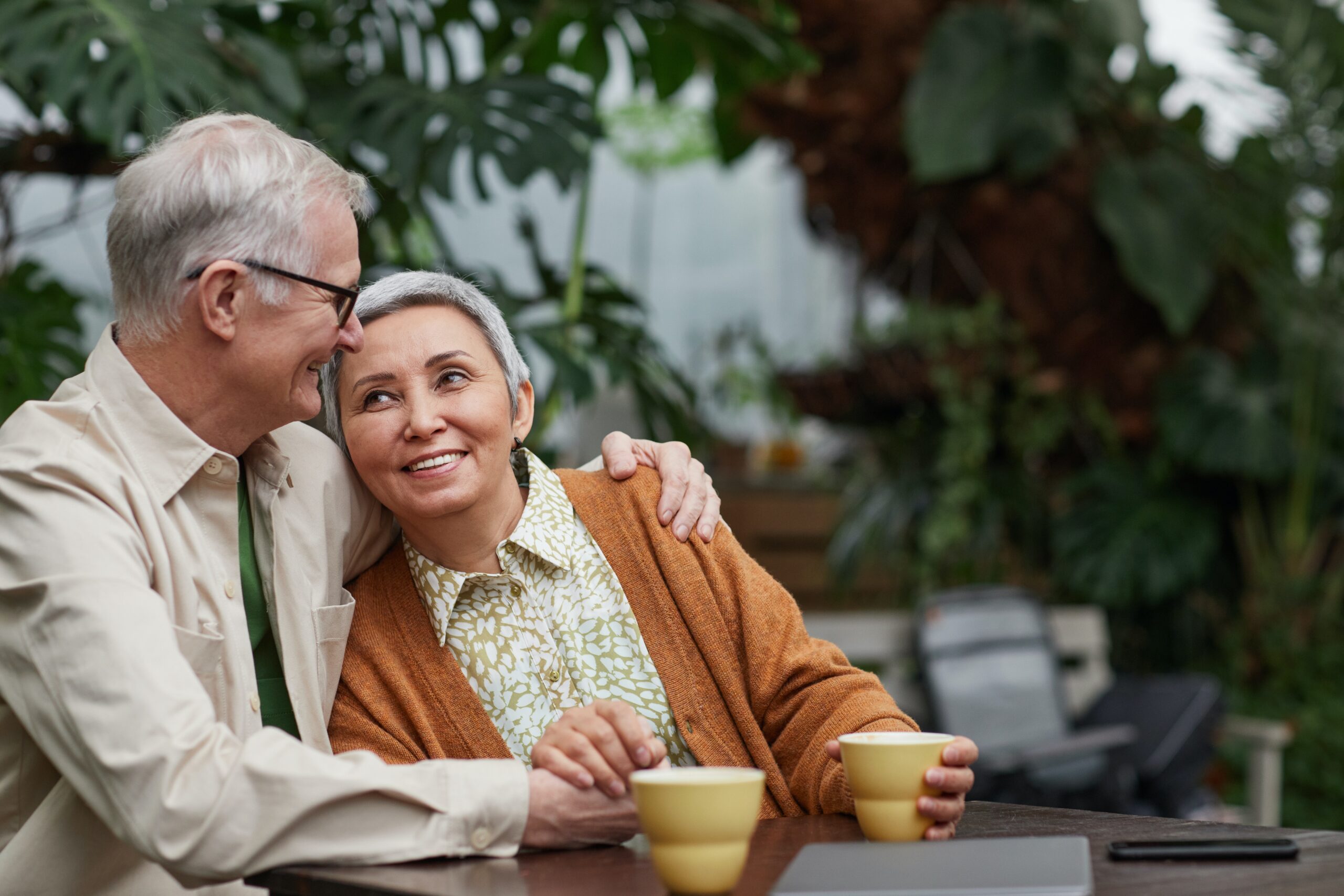 Older couple enjoying a warm beverage outside