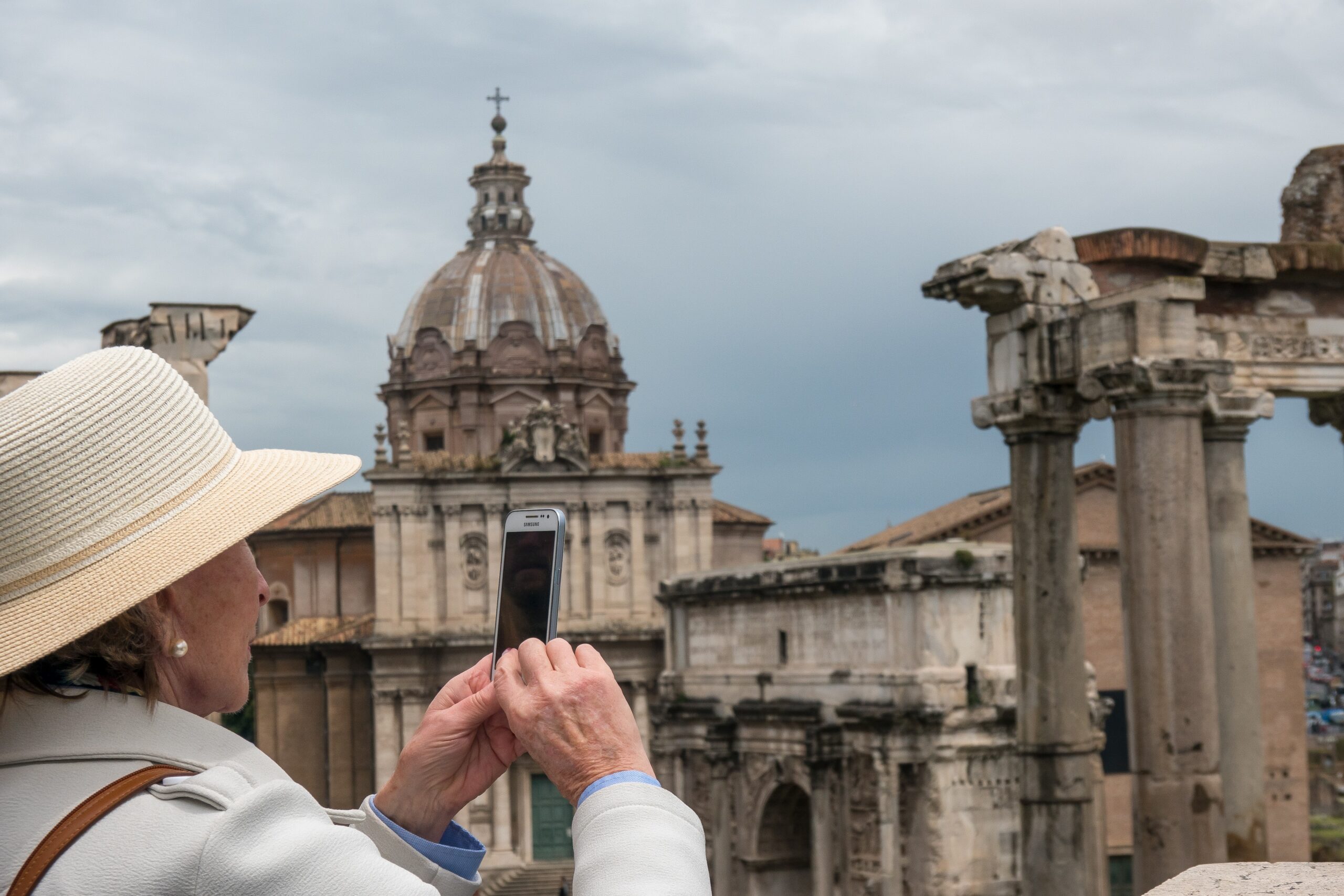 Older woman taking photo of scenery